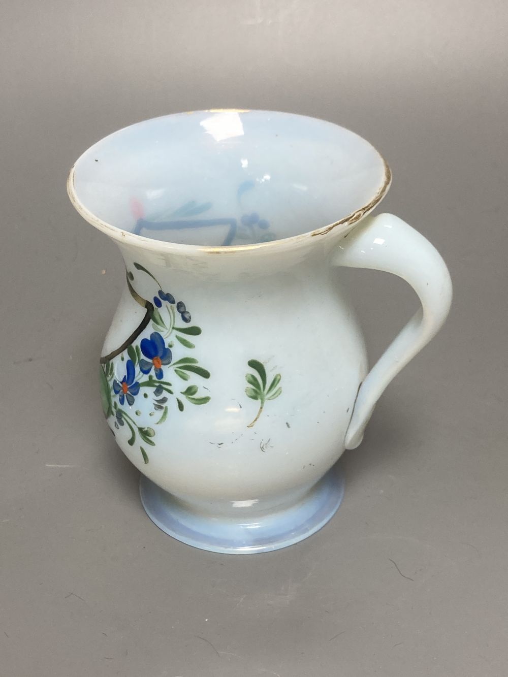 A Bohemian amber flash cut beaker vase, a pair of amber wine glass coolers, 10cm high and a floral painted opaque glass beaker vase, in